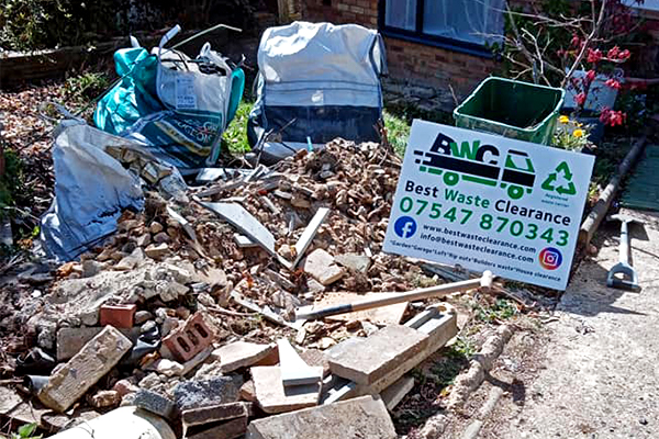 Construction waste in garden ready to be collected.