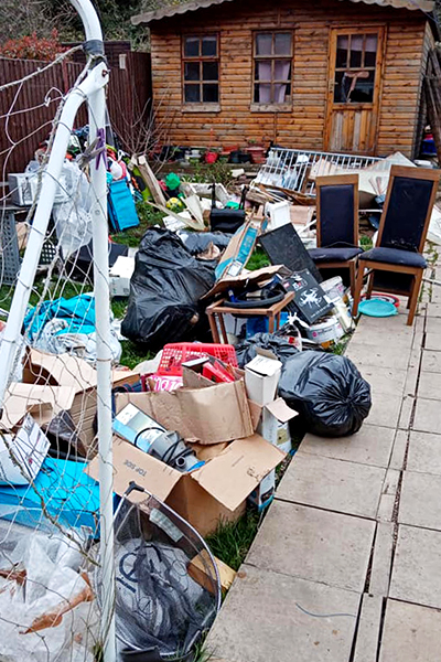 Customers garden full of household waste, ready to be dumped.